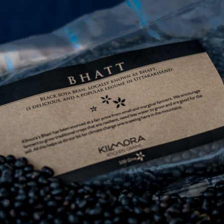 Packet of Bhatt or Black Soyabean with loose beans in the foreground