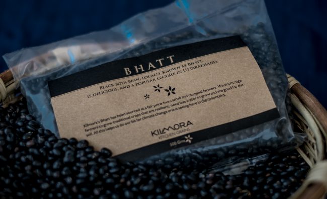 Packet of Bhatt or Black Soyabean with loose beans in the foreground