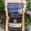 Kraft paper stand up pouch with black label giving information about Peppermint