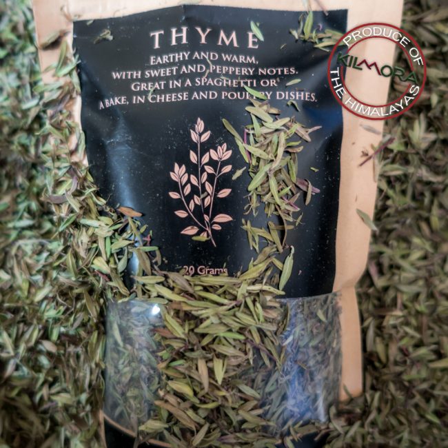 Kraft paper stand up pouch with black label giving information about the herb Thyme