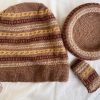 Hand knit woollen tea cosie set with a base, teapot cover and a flap to hold the handle