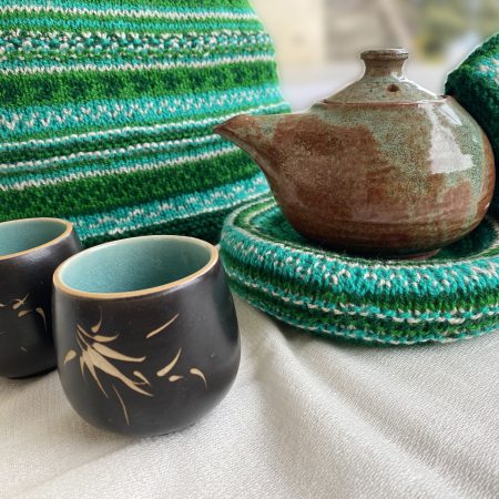 Hand knit woollen tea cosie set with a base, teapot cover and a flap to hold the handle