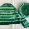 Hand knit woollen tea cosie set with a base, teapot cover and a flap to hold the handle