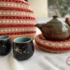 Hand knit woollen tea cosie set with a base, teapot cover and a flap to hold the handle