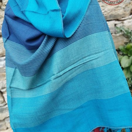 Handwoven women's woollen shawl from Kilmora in horizontal stripes of shades of winter skies. With blues ranging from azure to cobalt.
