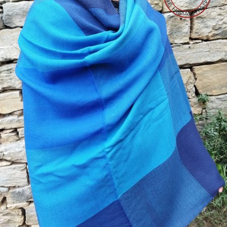 Handwoven women's woollen shawl from Kilmora in shades of blue ranging from indigo to turquoise and azure.