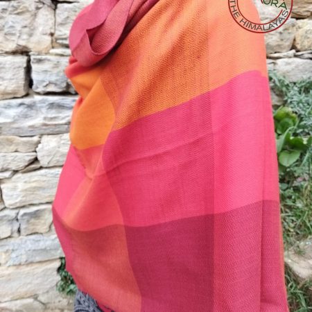 Handwoven women's woollen shawl from Kilmora in bold horizontal stripes with interwoven checks of bright orange, crimson, vermillion and salamander.