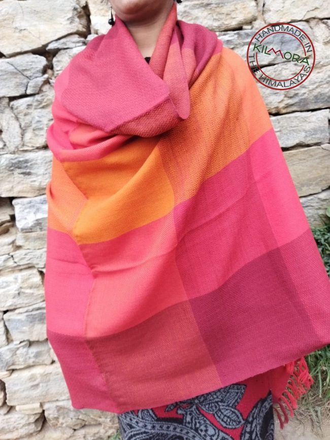 Handwoven women's woollen shawl from Kilmora in bold horizontal stripes with interwoven checks of bright orange, crimson, vermillion and salamander.