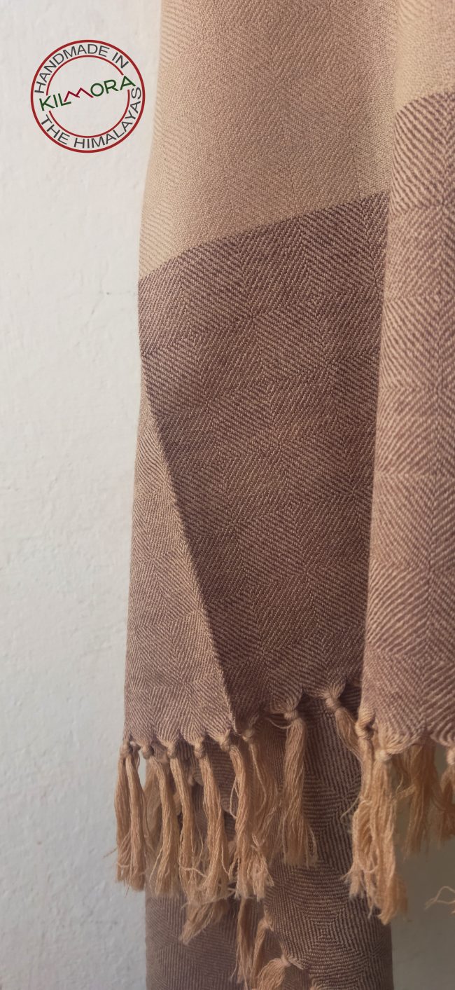 Classic handwoven shawl in light peach with simple broad border of double shaded maroon and peach. A neutral colour that looks chic with a saree or with a formal Western wear.