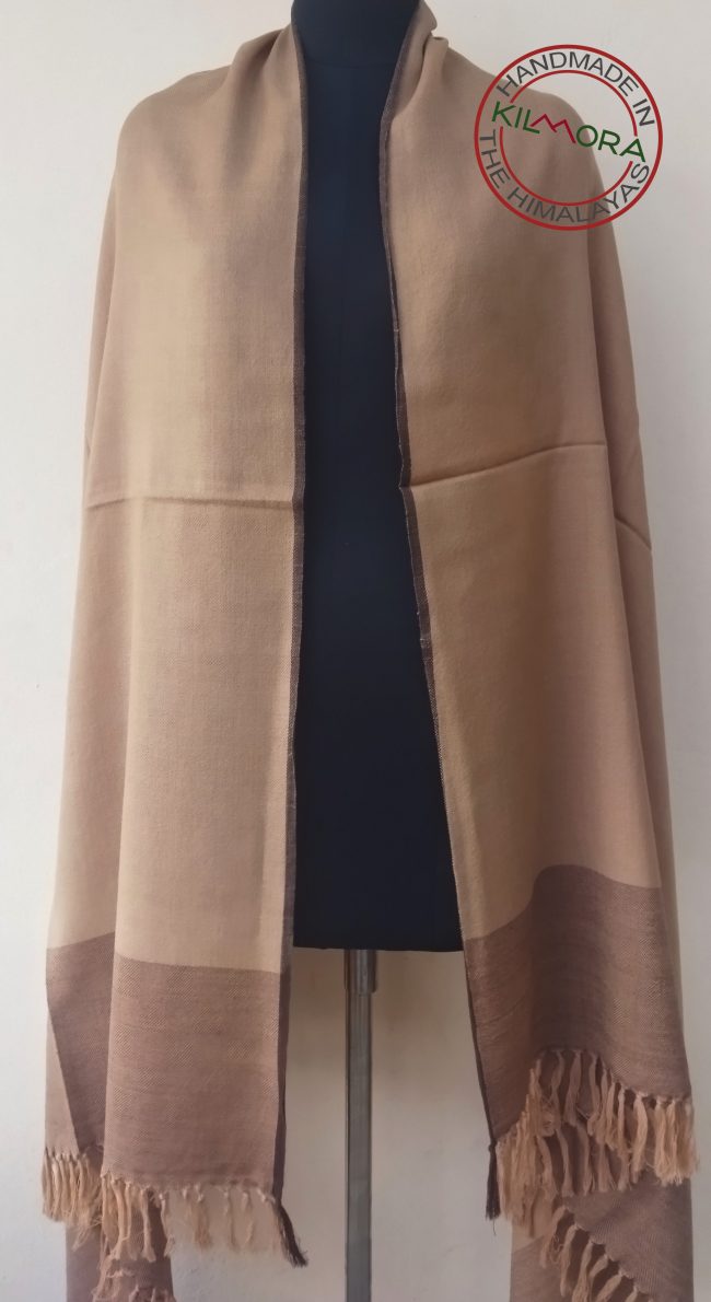 Classic handwoven shawl in light peach with simple broad border of double shaded maroon and peach. A neutral colour that looks chic with a saree or with a formal Western wear.