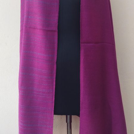 Handwoven shawl from Kilmora with fuchsia pink with subtle turquoise blue vertical stripes at the border. Guaranteed to brighten up a dull winter day or mood.