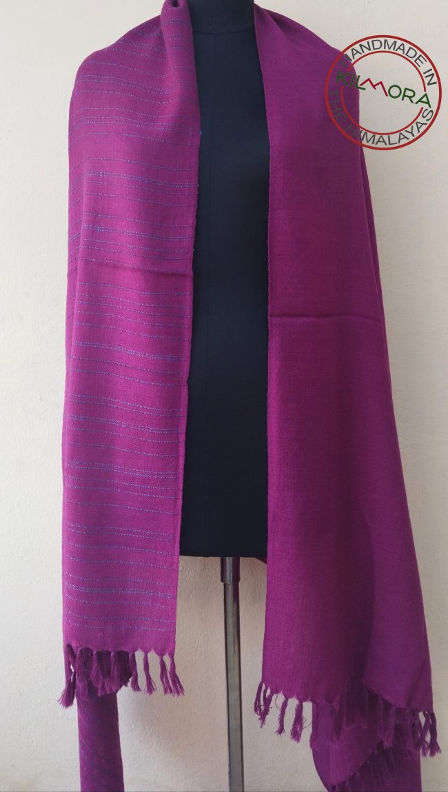 Handwoven shawl from Kilmora with fuchsia pink with subtle turquoise blue vertical stripes at the border. Guaranteed to brighten up a dull winter day or mood.