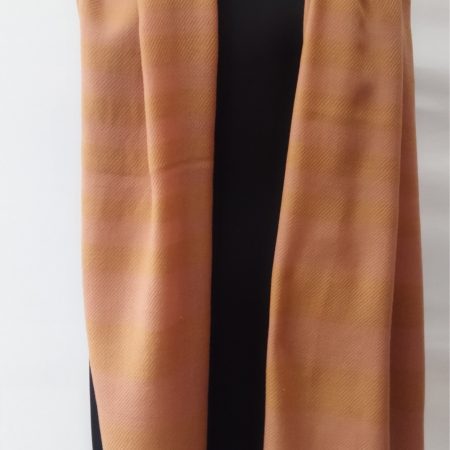 Pure merino wool hand-woven stole in vertical stripes of cream and gold.