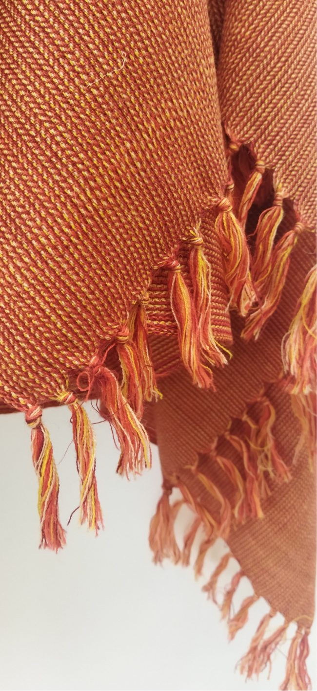 Handwoven shawl from Kilmora in tangerine with a beautiful weave pattern to elevate this shawl to one of effortless style and chic.