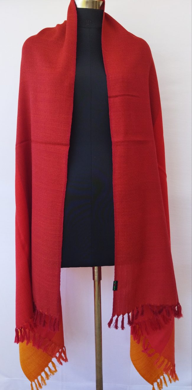 Handwoven pure merino wool shawl from Kilmora with in vertical stripes the colour of our autumn skies. Stripes in shades of carmine, scarlet, red, fiery orange and marigold.