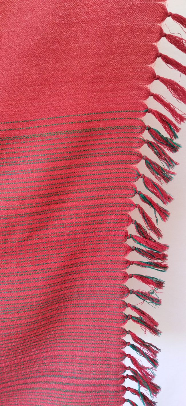 Handwoven pure merino wool shawl from Kilmora in ruby red with graduated thin horizontal stripes in black in the bottom half.