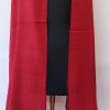 Handwoven pure merino wool shawl from Kilmora in ruby red with graduated thin horizontal stripes in black in the bottom half.