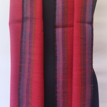Pure merino wool scarf in gorgeous crimson and edged with a border of black, turquoise, pink, purple and brown.
