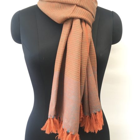 Self striped merino wool stole from Kilmora in cantaloupe orange with an undertone of azure.