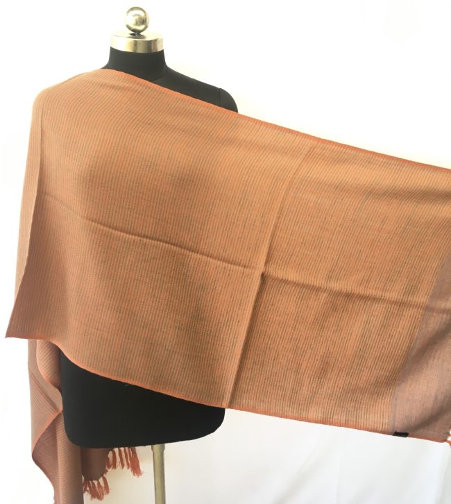 Self striped merino wool stole from Kilmora in cantaloupe orange with an undertone of azure.