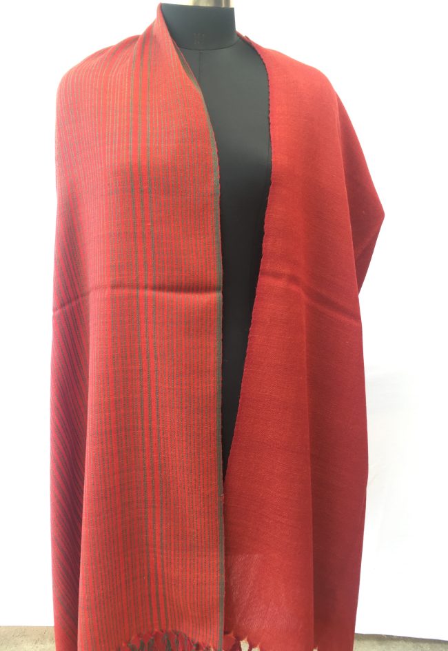 Merino wool shawl with sage green vertical stripes giving way to solid tomato red block at the bottom