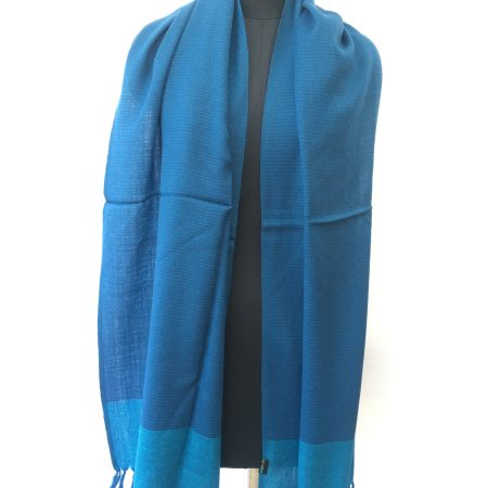 Deep cerulean blue self striped merino wool stole from Kilmora. With a lighter cerulean in bold border.