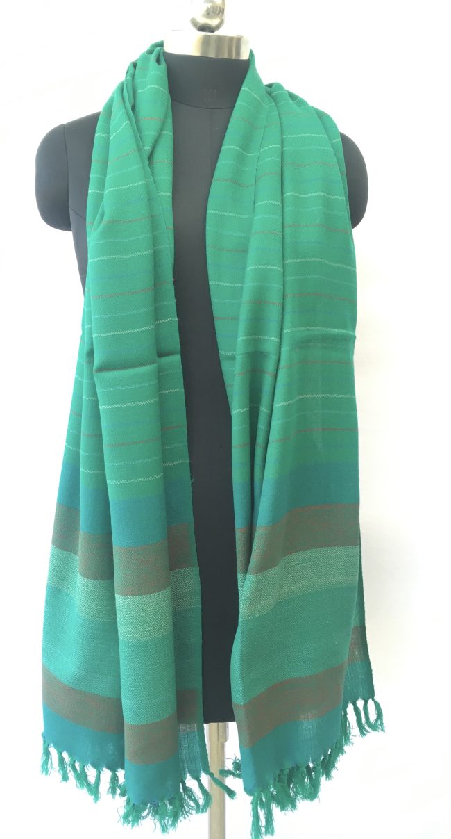 Jade coloured merino wool stole from Kilmora. With an end border with vertical stripes of teal, double shaded mix of moss green and orange