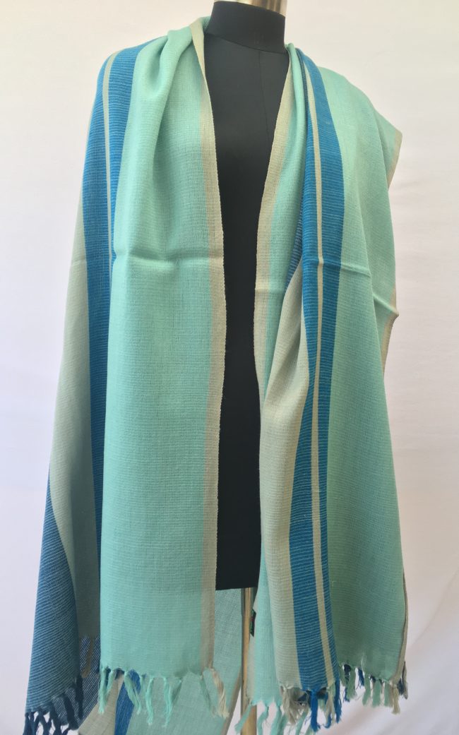 Merino wool shawl from Kilmora. In bold variegated stripes of sky blue, cerulean, grey and indigo