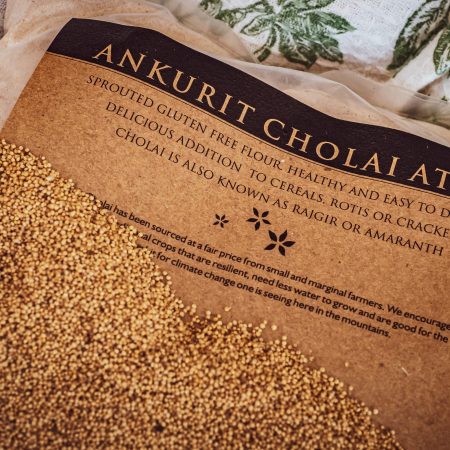 Label saying Ankurit Cholai Atta or Sprouted Amaranth Flour with sprouted amaranth seeds strewn on the packet