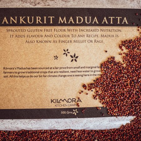 Label saying Ankurit Madua Atta or Sprouted Finger millet Flour with sprouted finger millet strewn across the packet