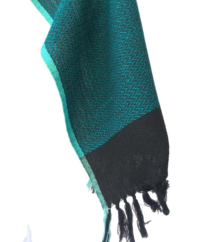 Pure merino wool scarf in double shaded pattern of peacock blue and black. And edged with a turquoise blue border.