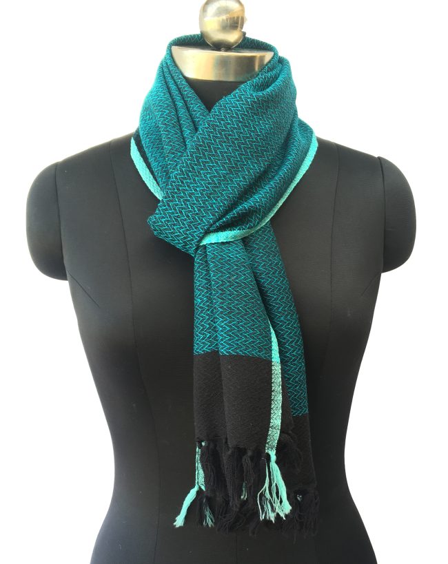 Pure merino wool scarf in double shaded pattern of peacock blue and black. And edged with a turquoise blue border.