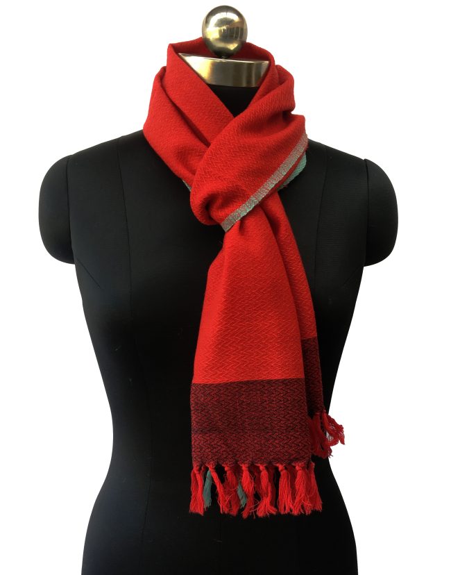 Pure merino wool scarf in bright candy red. Edged with turquoise blue and with a border of double shaded red and black.