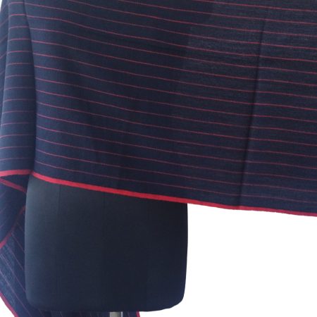 Merino wool stole in deep navy blue with thin horizontal pin stripes in red shown on a mannequin.