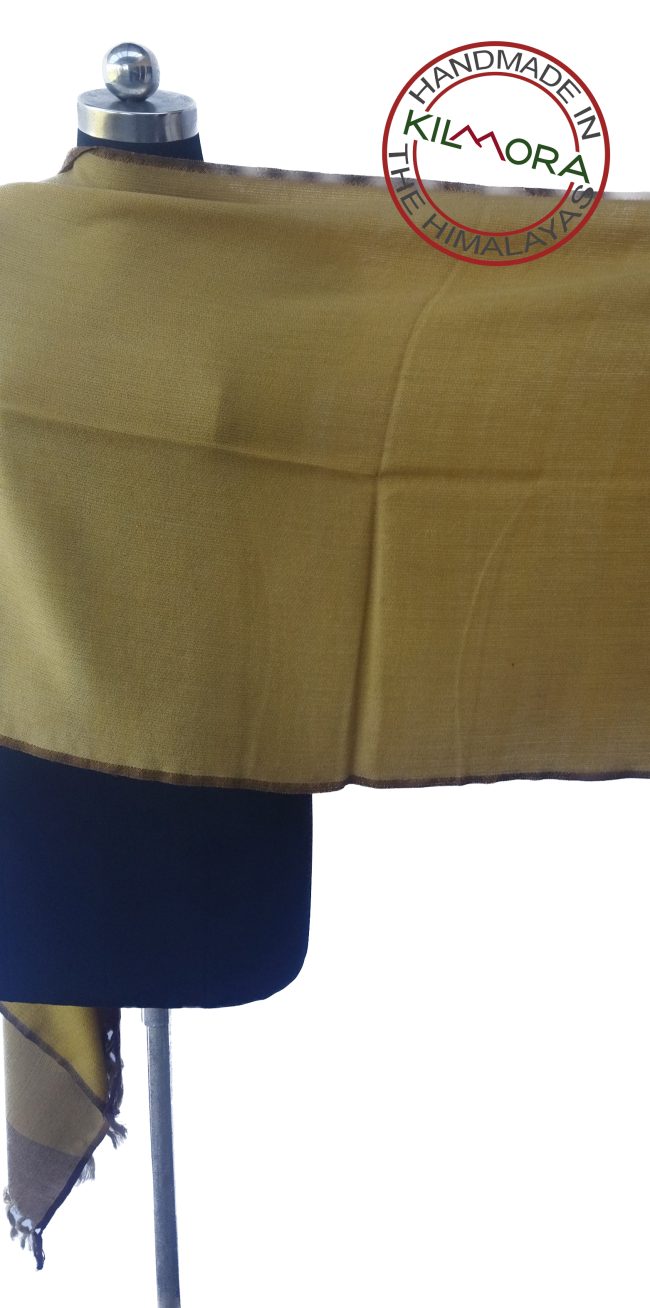 Ginger merino wool stole draped on a mannequin