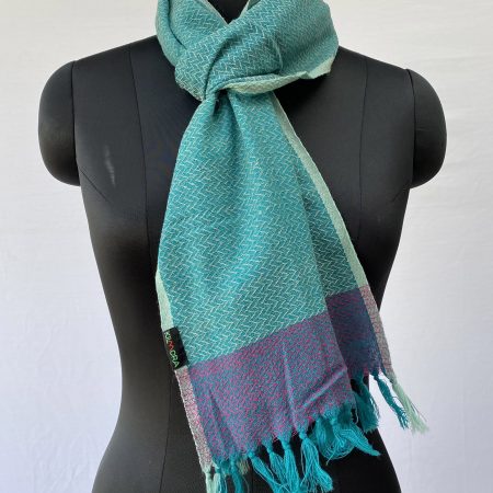 Pure merino wool turquoise scarf with herringbone pattern and with a border in navy blue