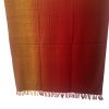 Handwoven merino wool shawl in gradation with shades from deep apricot to tangerine and ending in mahogany