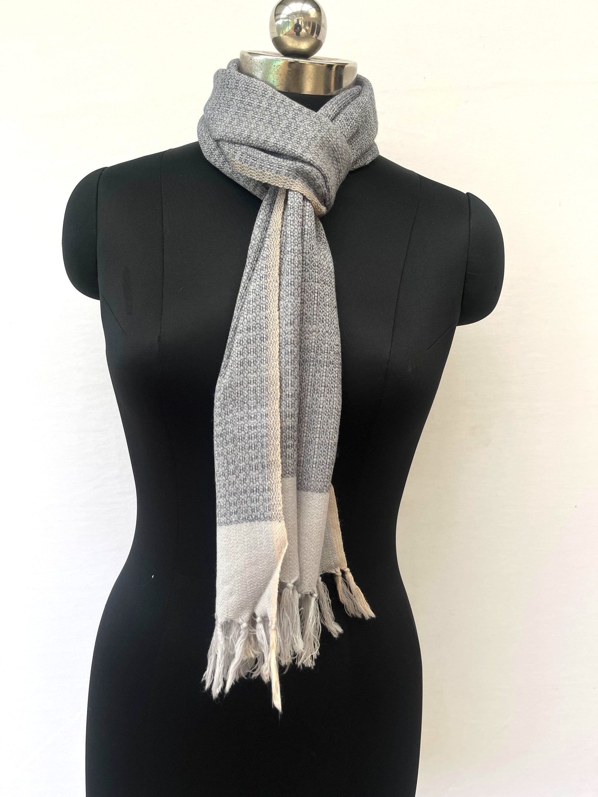 Handwoven merino wool scarf with a basket weave in black on a cream background, with a wide cream border at the end.