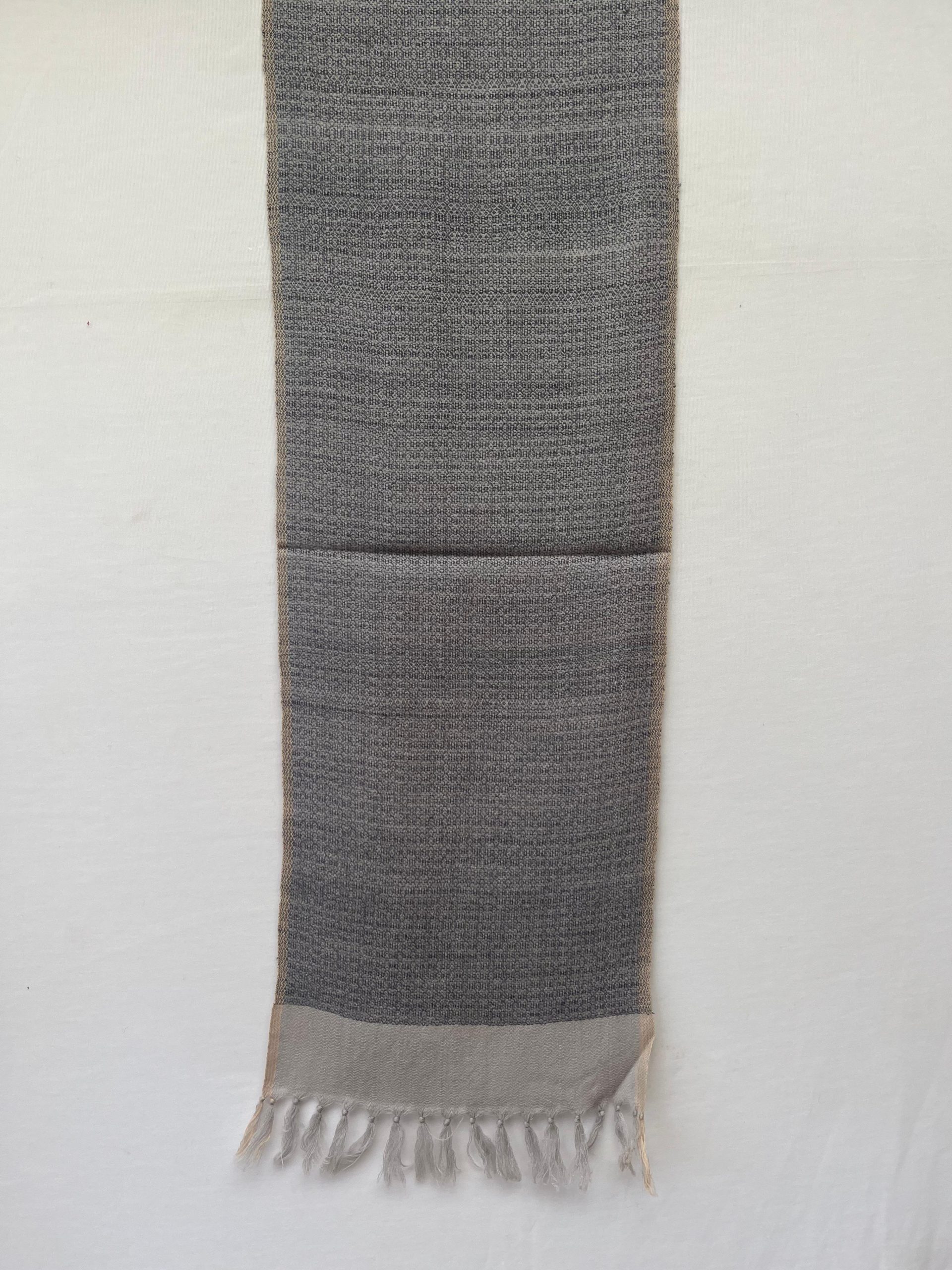 Handwoven merino wool scarf with a basket weave in black on a cream background, with a wide cream border at the end.