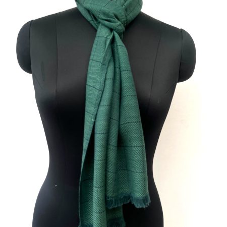 Handwoven merino wool scarf in deep pine green. Interwoven with navy blue checks.