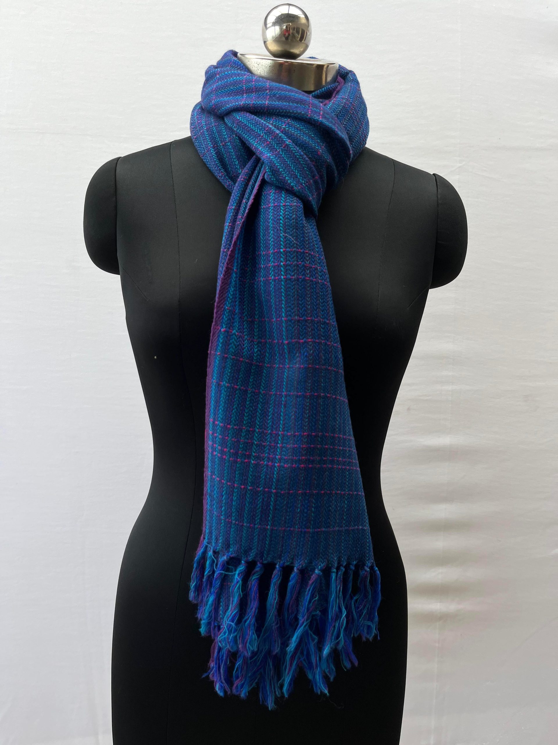 Azure blue merino wool stole with elements of cobalt blue, and pink woven in in stripes and checks.
