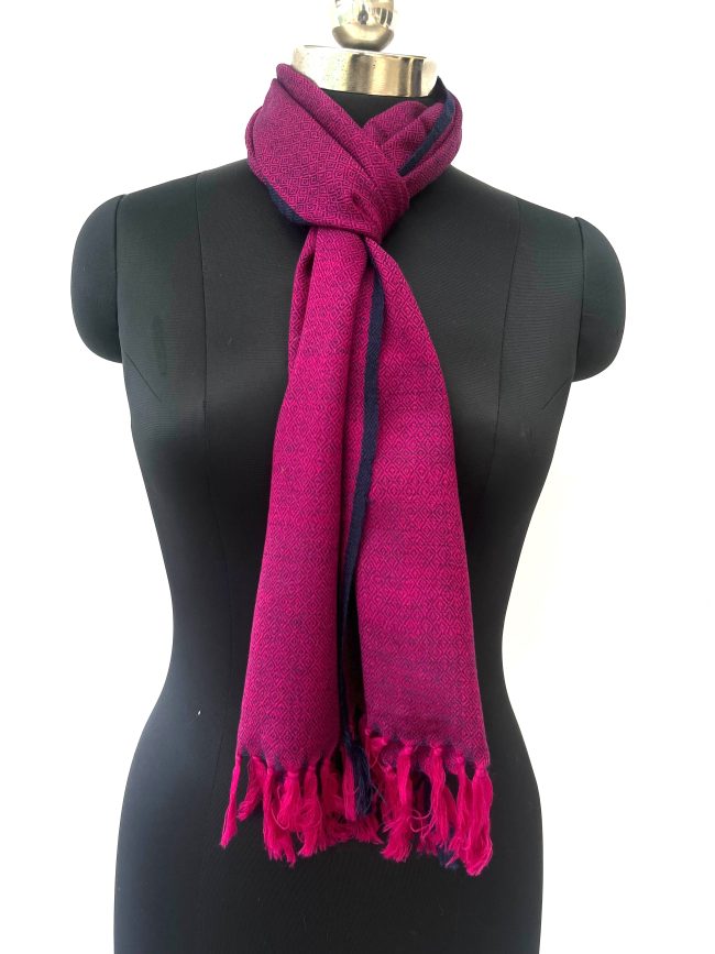 Handwoven merino wool scarf in purple with a diamond pattern and a thin navy blue selvedge