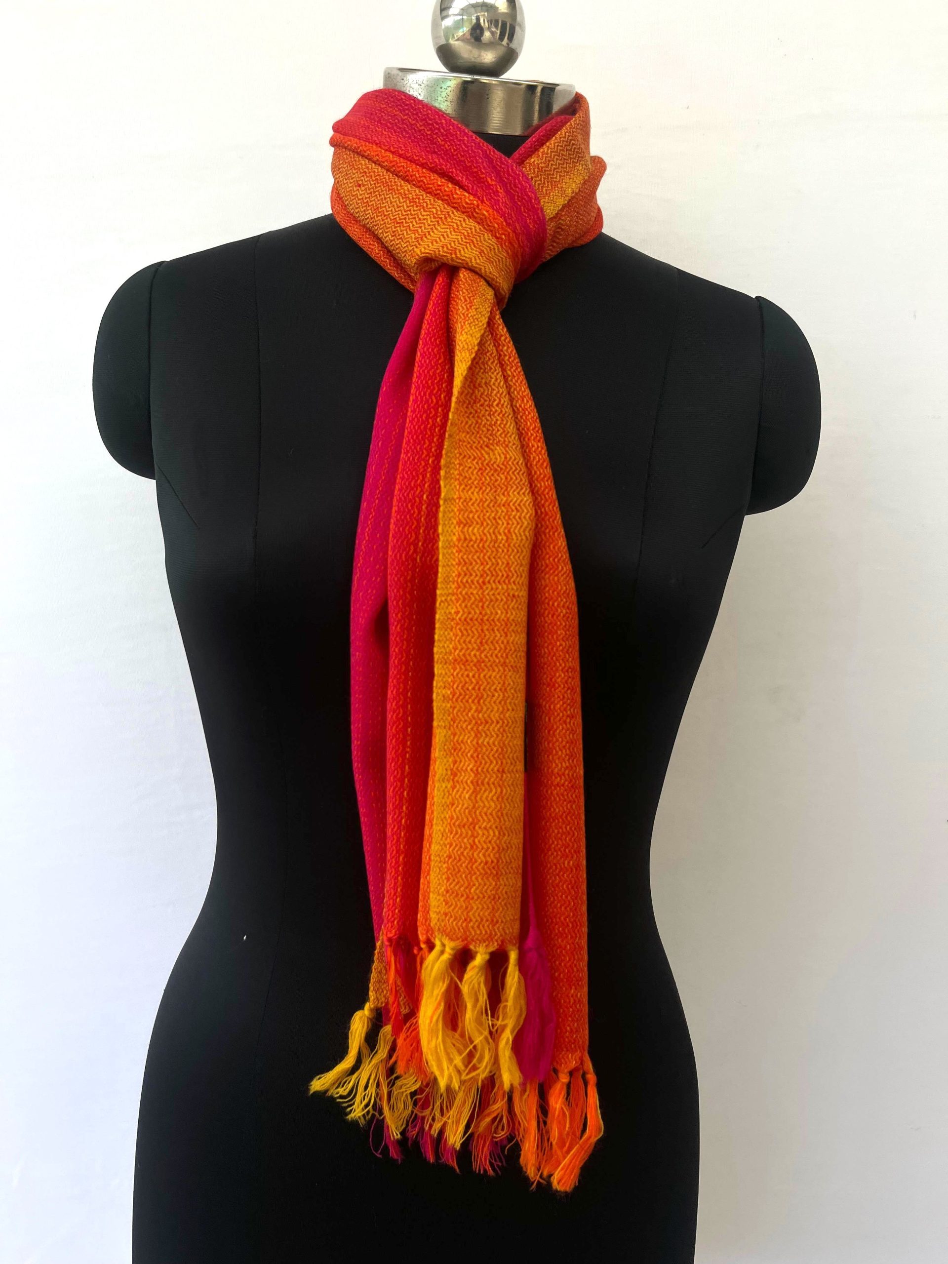Merino wool scarf woven in vertical ombre shades of yellow, deep orange and red