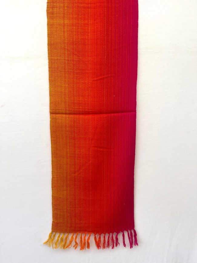 Merino wool scarf woven in vertical ombre shades of yellow, deep orange and red