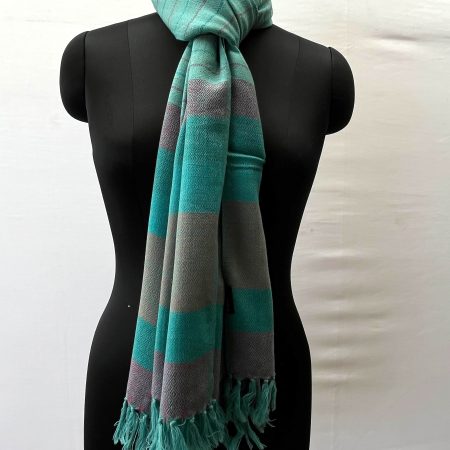 Handwoven merino wool stole in teal. With an end border of vertical stripes in red, deep green, teal, brown, deep green and ending with red