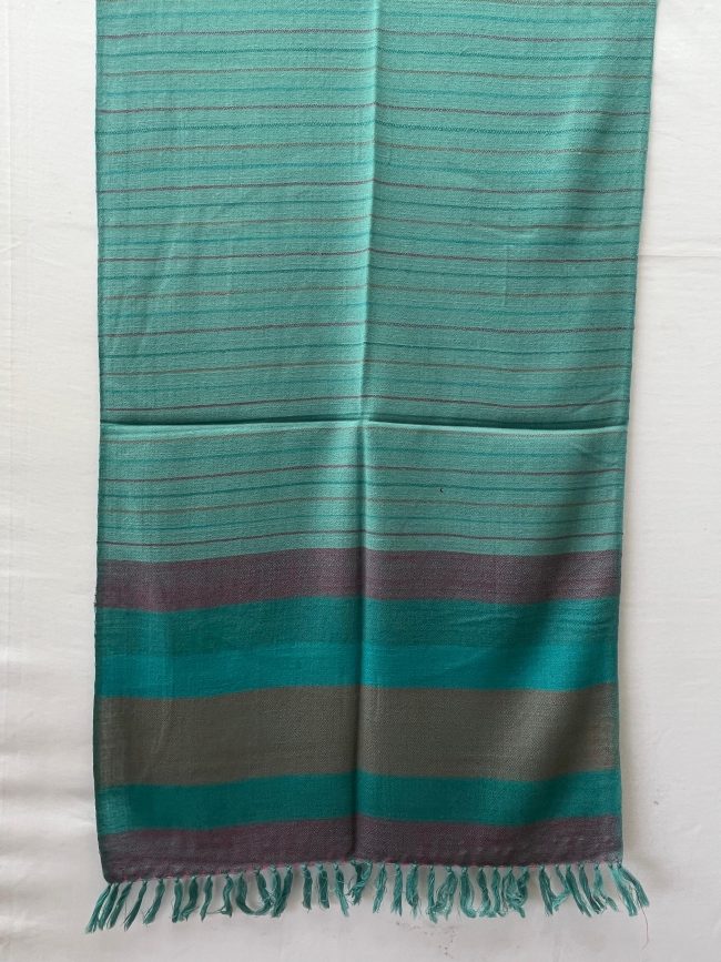 Handwoven merino wool stole in teal. With an end border of vertical stripes in red, deep green, teal, brown, deep green and ending with red