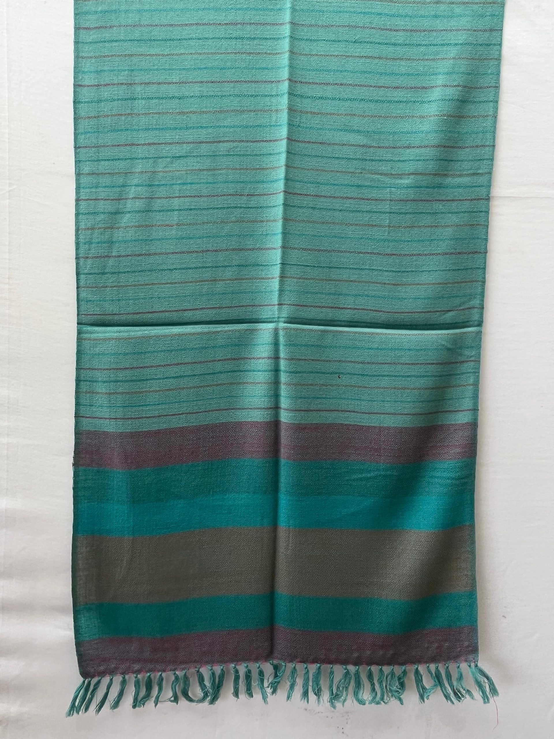Handwoven merino wool stole in teal. With an end border of vertical stripes in red, deep green, teal, brown, deep green and ending with red
