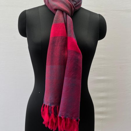 Double shaded merino wool stole in purple and magenta, with a bright neon pink vertical border at the end of the stole
