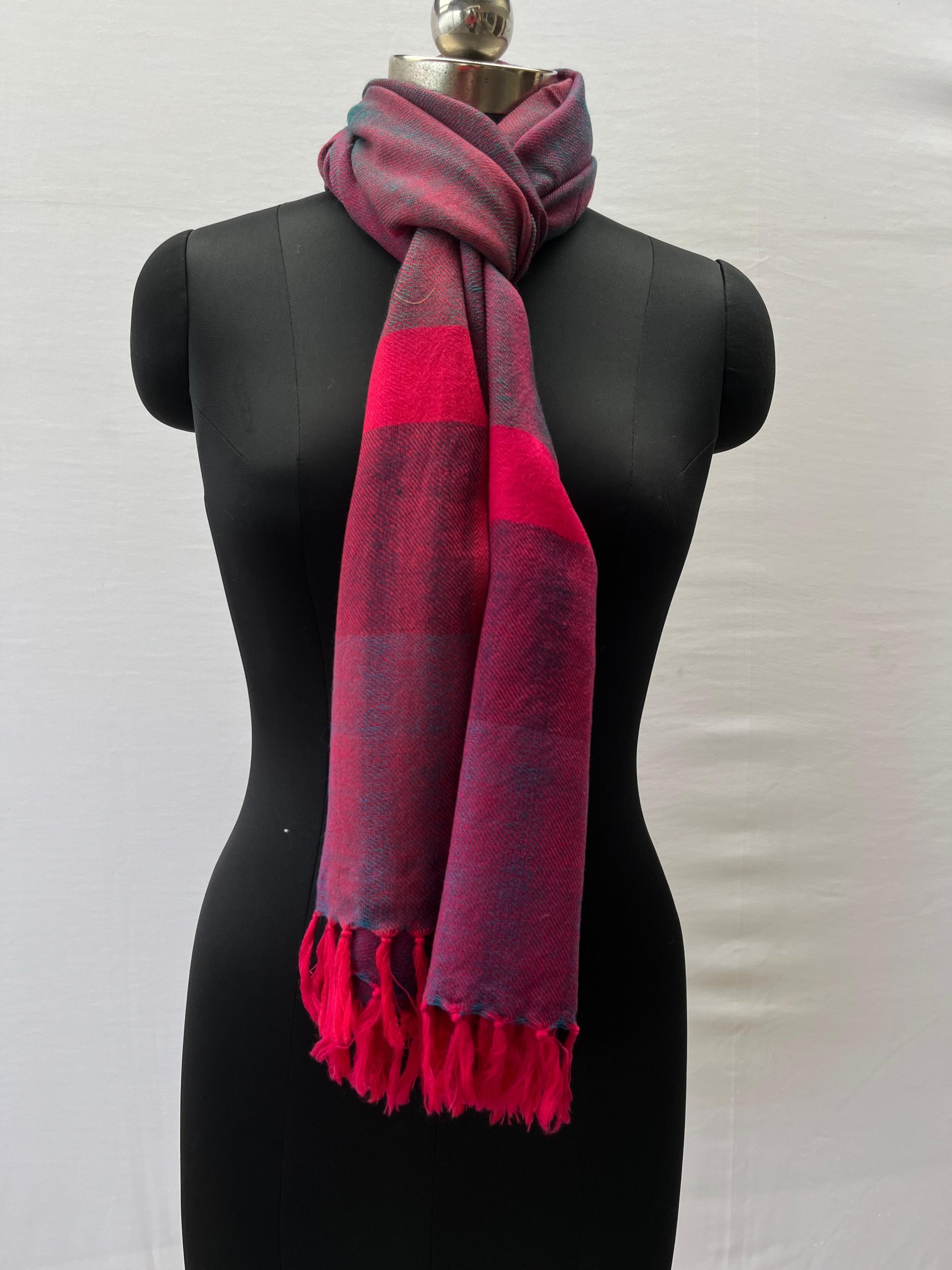 Double shaded merino wool stole in purple and magenta, with a bright neon pink vertical border at the end of the stole