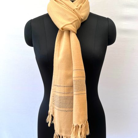 Handwoven merino wool stole in light lemon. And ends with a dotted navy blue border.